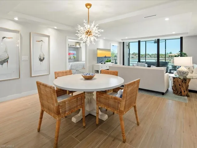 Dining area featuring recessed lighting, light wood-style floors, and a chandelier