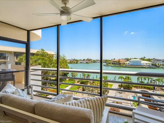 Sunroom featuring a water view