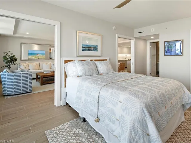 Bedroom with wood tiled floors, recessed lighting, ceiling fan, and connected bathroom
