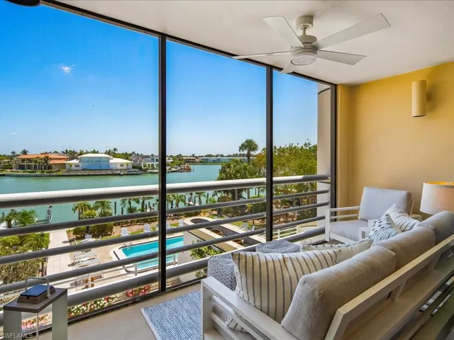 Sunroom featuring a water view