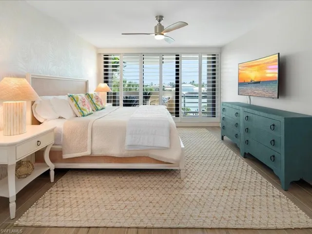 Bedroom featuring wood finished floors and a ceiling fan