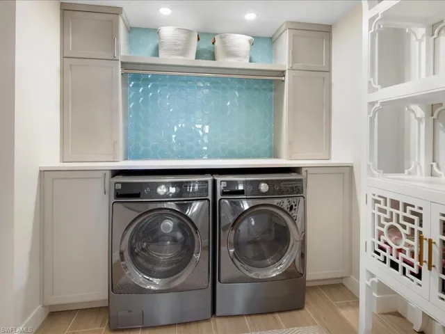 Laundry area featuring independent washer and dryer and light wood finished floors