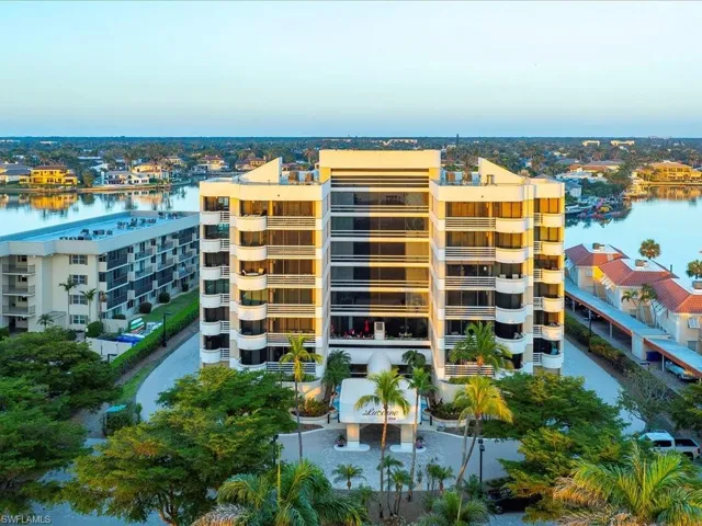 View of apartment building / complex featuring a water view