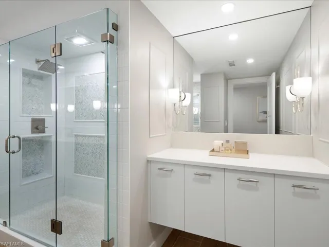 Bathroom featuring vanity, a stall shower, dark wood-style floors, and recessed lighting