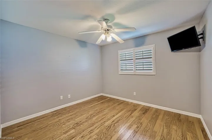 Unfurnished room featuring ceiling fan and light hardwood / wood-style flooring