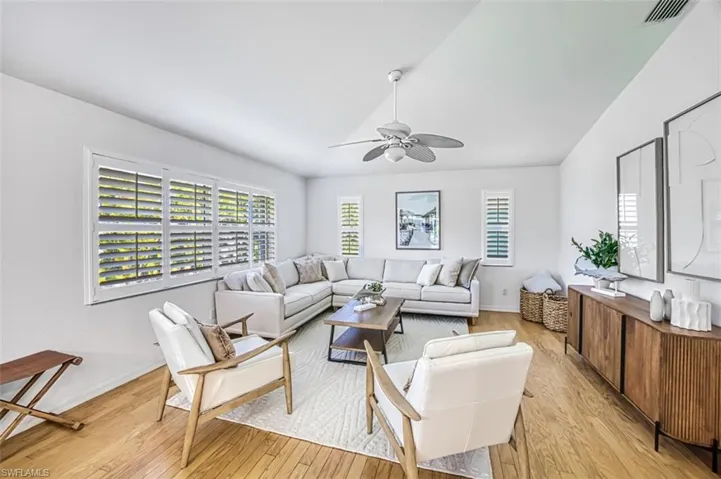 Living room featuring light wood-type flooring and ceiling fan