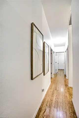 Corridor with light wood-type flooring