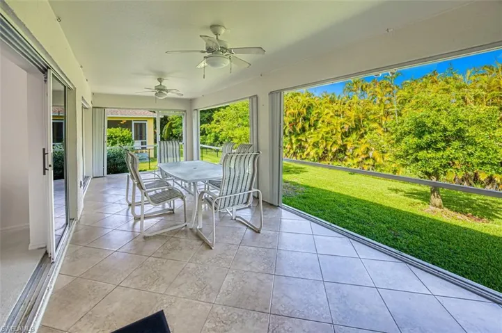 Unfurnished sunroom featuring ceiling fan