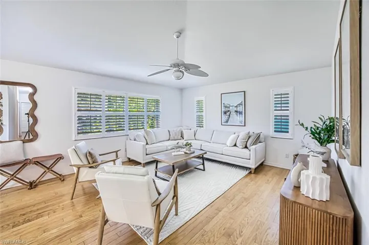Living room featuring light hardwood / wood-style floors and ceiling fan