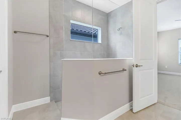 Full bathroom featuring baseboards and a walk in shower