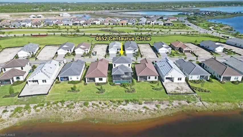 Aerial view of residential area featuring a large body of water