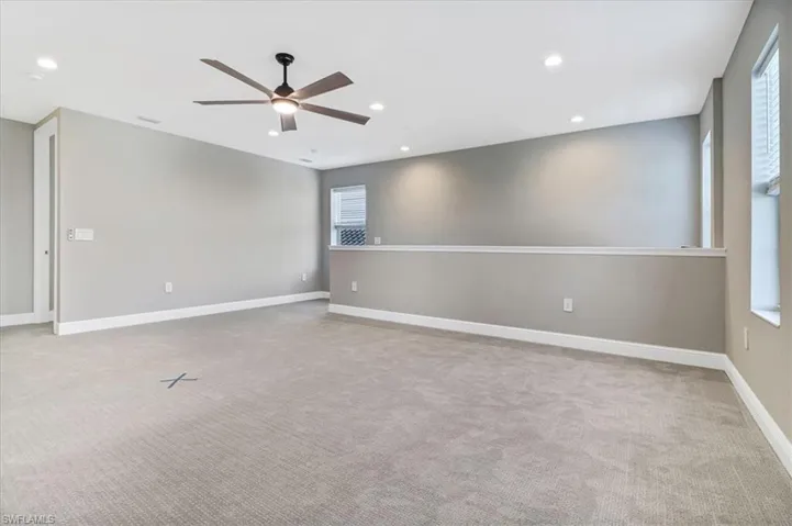 Unfurnished room featuring a ceiling fan, recessed lighting, and light colored carpet