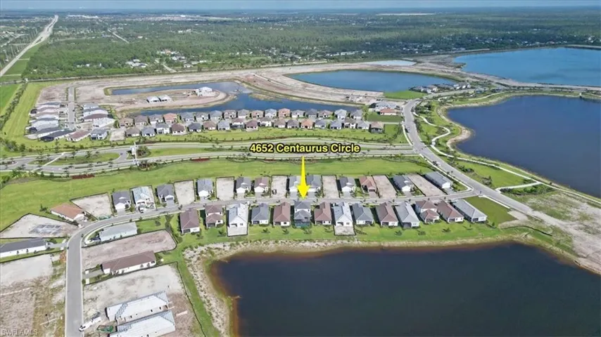 Aerial view of property's location featuring nearby suburban area and a nearby body of water