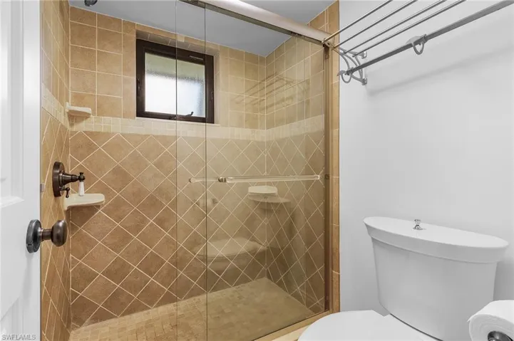 Bathroom with toilet and a shower with shower door