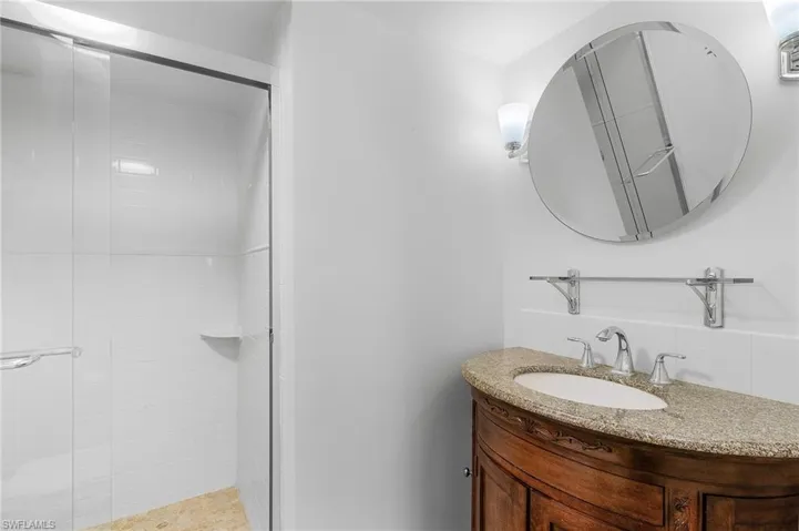 Bathroom with vanity and a shower with shower door