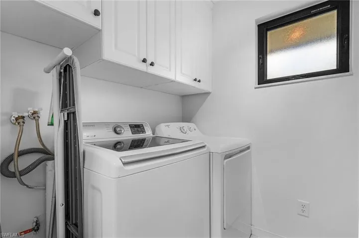 Laundry area with cabinets and independent washer and dryer