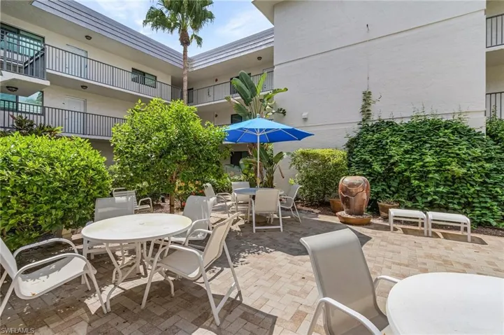 View of patio with a balcony
