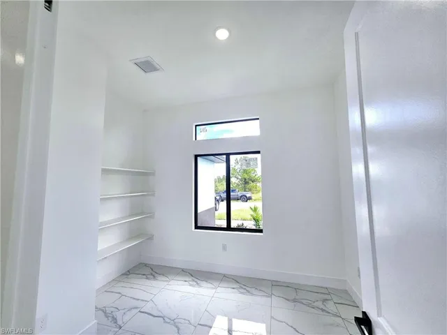 Spare room featuring light tile patterned floors
