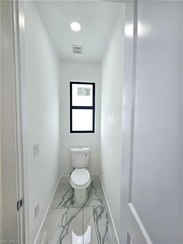 Bathroom with toilet and tile patterned floors