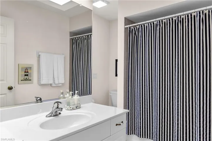 Full bathroom featuring vanity and a shower with curtain