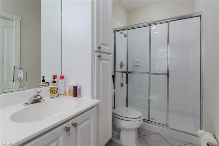 Main bathroom has tile floors and tiled shower