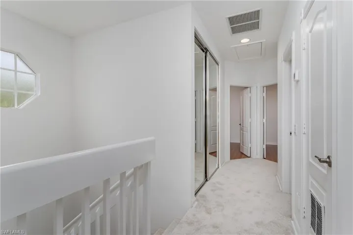 Hallway leading to BR's #2 & #3.  New carpet, large mirrored closet.
