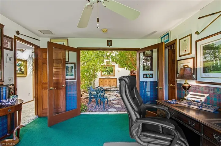 Office area featuring carpet, plenty of natural light, and a ceiling fan