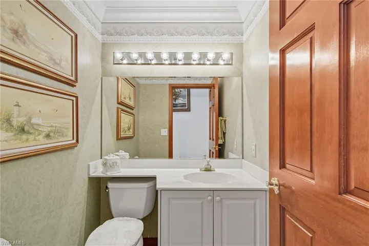 Half bath with vanity and ornamental molding