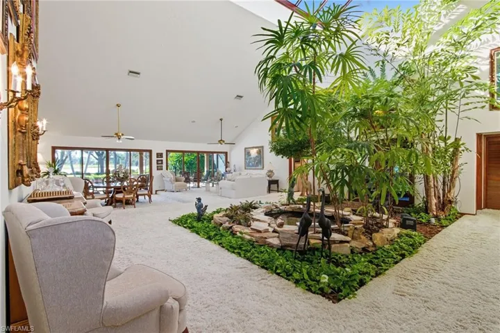 Large atrium room with water feature gives an "in touch with nature" feel to the room.