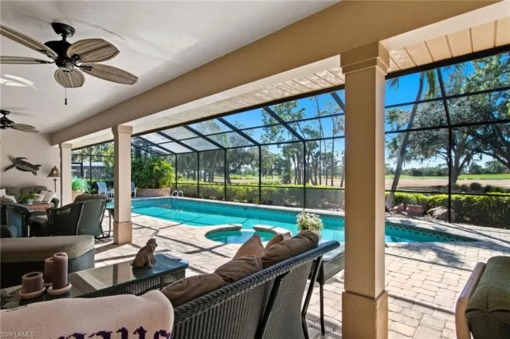 Outdoor pool with outdoor lounge area, a sunroom, and a patio