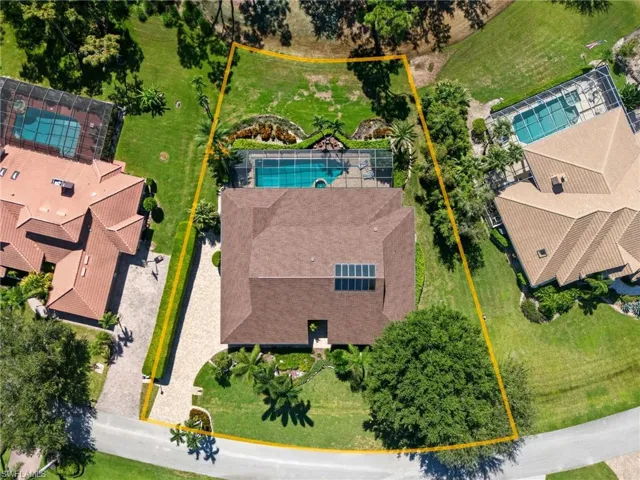 Aerial view of property and surrounding area with a pool and property parcel outlined