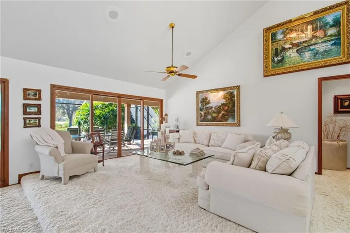 Entertaining area with high vaulted ceiling and sliders out to the lanai.