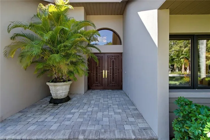 Very welcoming entry with brick pavers and double entry doors.