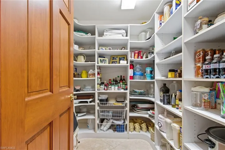 Check out the space in this large walk-in pantry with built-ins.