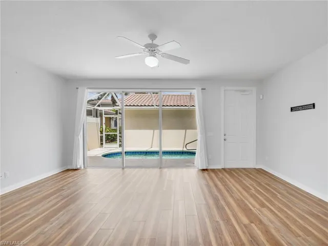 Unfurnished room featuring ceiling fan and hardwood / wood-style flooring