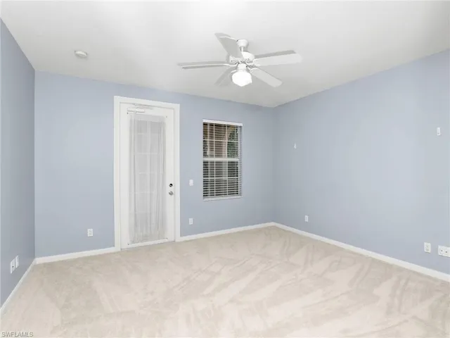 Spare room featuring ceiling fan and light carpet