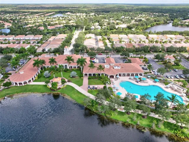 Birds eye view of property with a water view