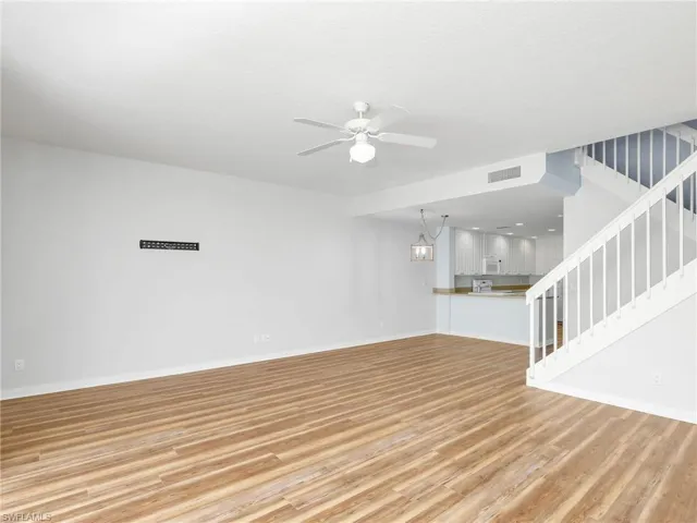 Unfurnished living room with hardwood / wood-style floors and ceiling fan
