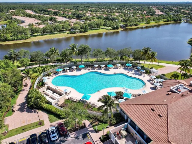 Birds eye view of property with a water view