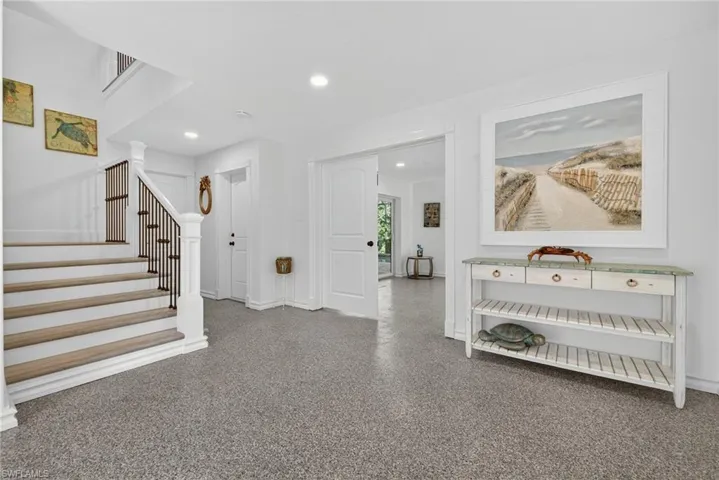 Entrance foyer with stairway, recessed lighting, and speckled floor