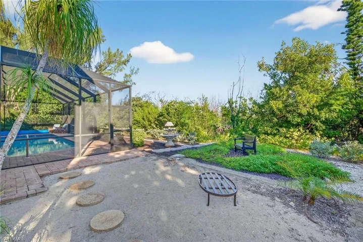 View of community with a sunroom, a swimming pool, and a patio area