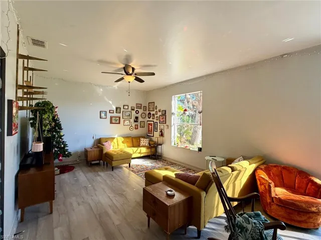 Living area featuring wood finished floors and ceiling fan