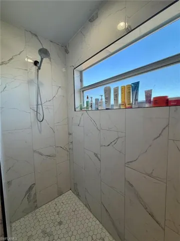 Bathroom with a marble finish shower