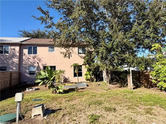 Rear view of house with stucco siding