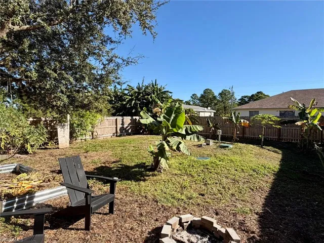 Fenced backyard featuring an outdoor fire pit