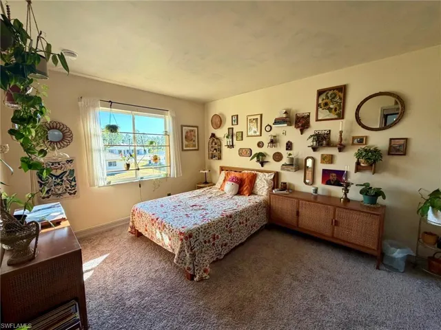 Carpeted bedroom featuring baseboards