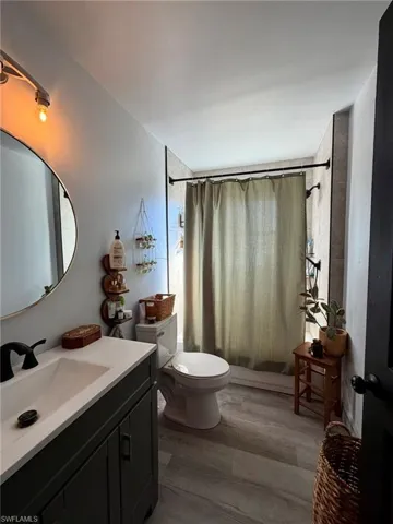 Bathroom featuring vanity and dark wood-style floors