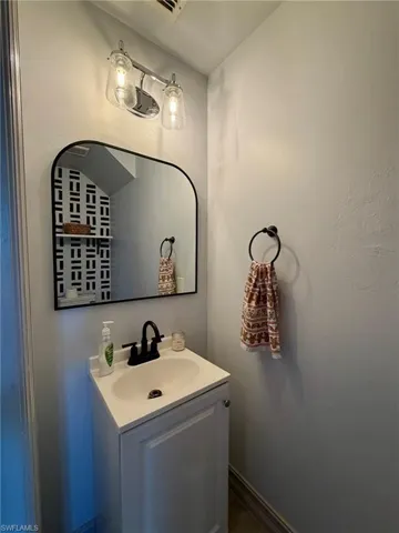 Bathroom with vanity and baseboards