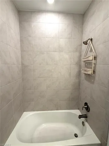 Full bath featuring shower / washtub combination