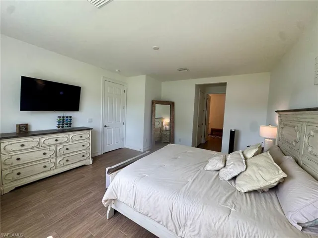 Bedroom featuring wood finished floors and baseboards
